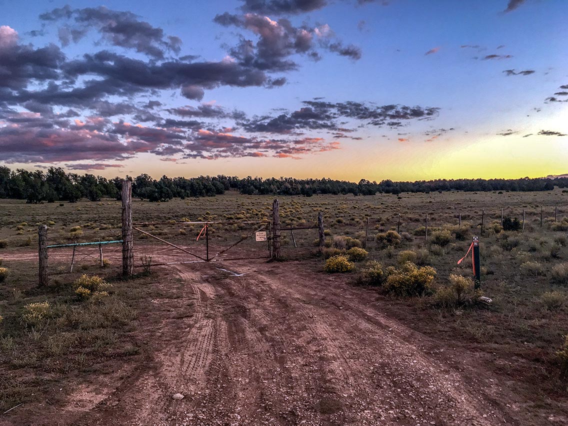 Sunset and livestock gate, Babbitt Ranch